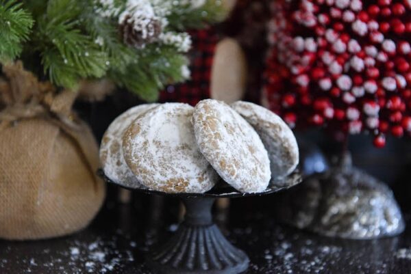 Pfeffernusse Cookies on dark cookie tray 