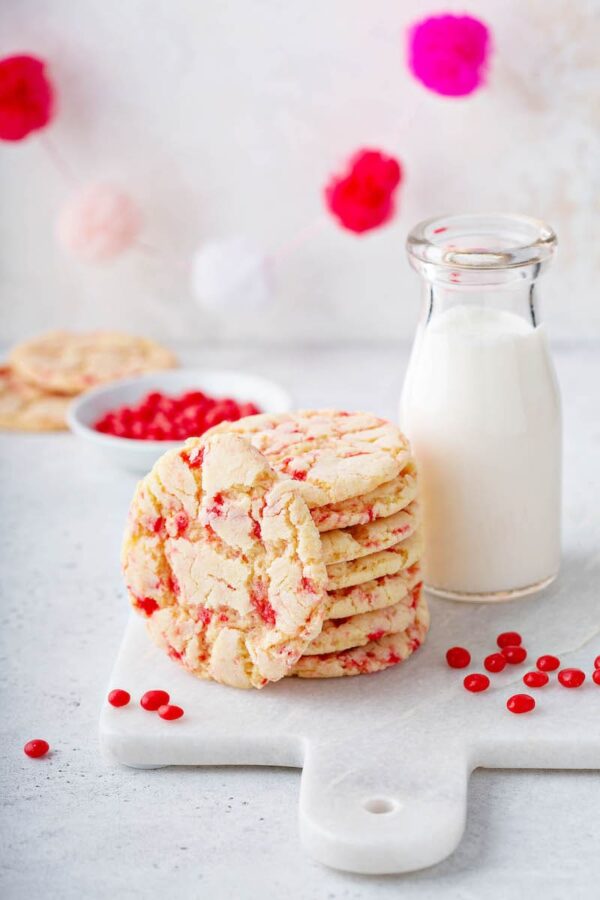 Red hot sugar cookies with a glass of milk. 