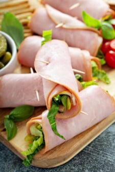 Ham roll ups with lettuce, mustard, cheese, and pickles.