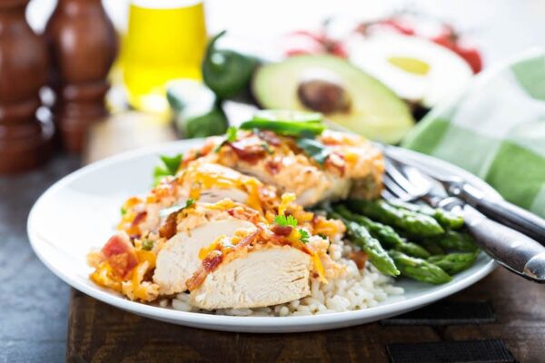 Sliced jalapeno popper chicken on a dinner plate. 