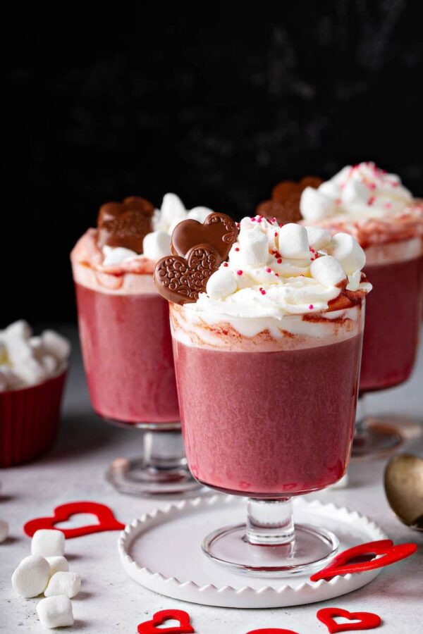 This rich and creamy Red Velvet Hot Chocolate has all the flavors of the classic cake, including a marshmallow whipped cream topping that tastes like frosting!