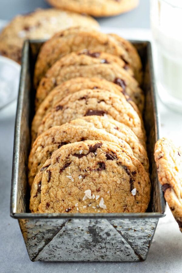 Chocolate Chunk Cookies with flaked sea salt in a pan. 