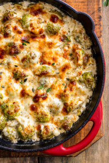 Creamy baked brussel sprouts in a cast-iron pan.