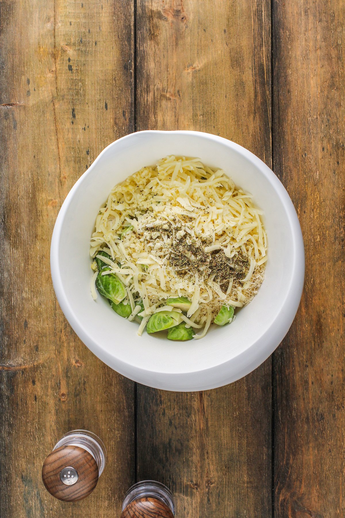 Ingredients for the creamy baked brussel sprouts in a bowl.