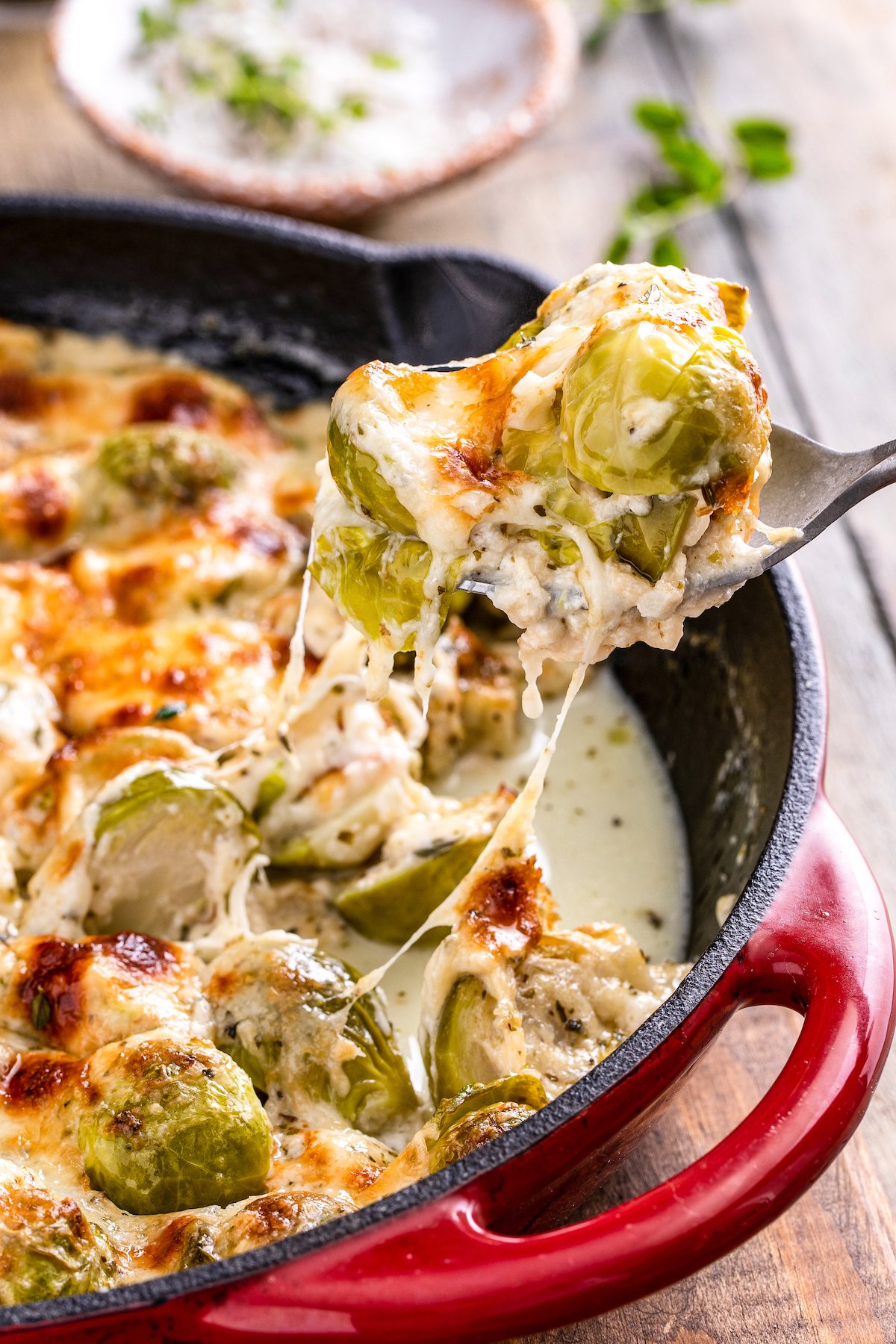Creamy baked brussel sprouts on a fork.