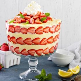 Large trifle bowl filled with lemon strawberry pudding trifle