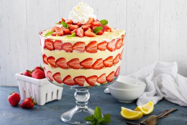 Large trifle bowl filled with lemon strawberry pudding trifle