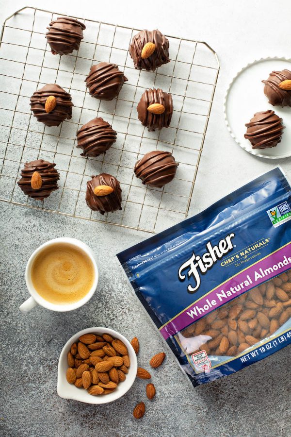 Almond Joy Truffles on a Cooling Rack Beside a Bag of Whole Natural Almonds