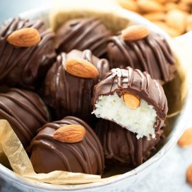 Almond Joy Truffles in a Bowl with the Top One Missing a Bite