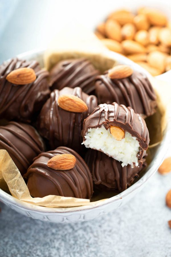 Almond Joy Truffles in a Bowl with the Top One Missing a Bite