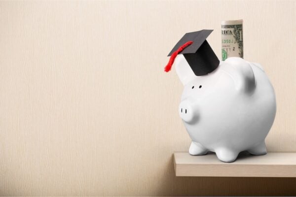 White piggy bank with a graduation hat on it.