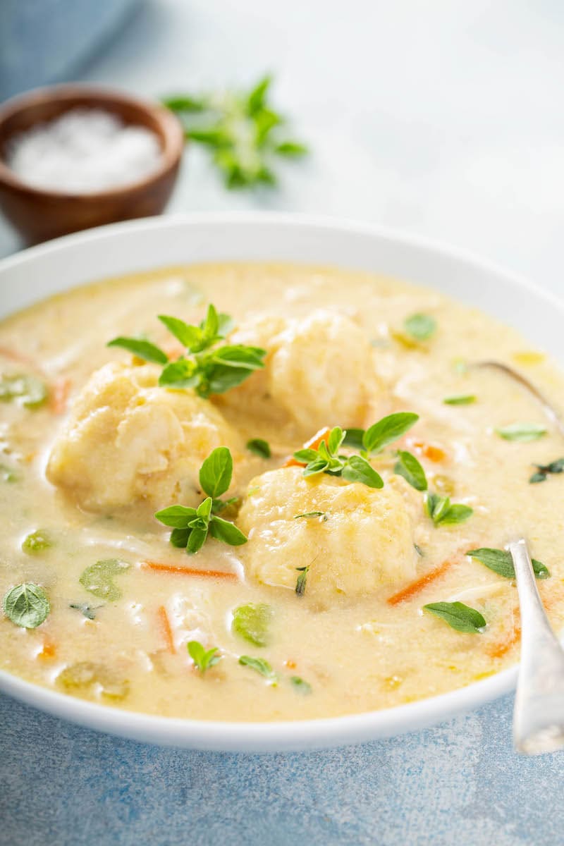 Crockpot chicken and dumplings in a large bowl with homemade dumplings from scratch! 