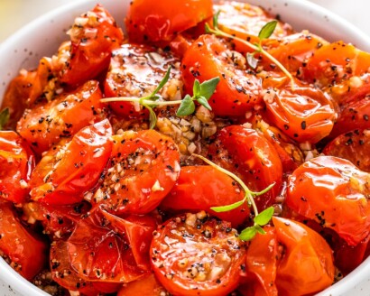 Close-up of roasted cherry tomatoes in a bowl.
