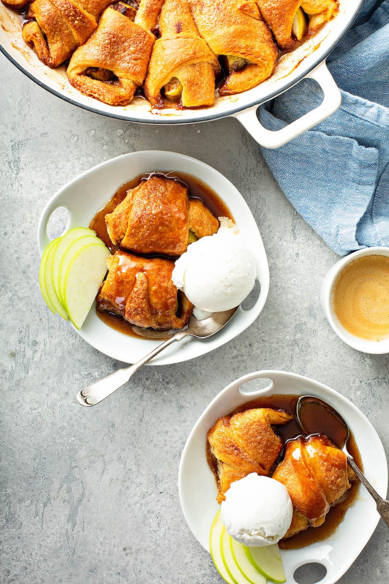 A large pan of cooked world dumplings and dumplings in bowls.