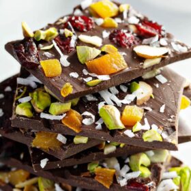 Six Pieces of Dark Chocolate Nut Bark Stacked on Top of One Another