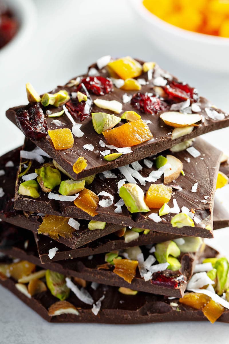 Six Pieces of Dark Chocolate Nut Bark Stacked on Top of One Another