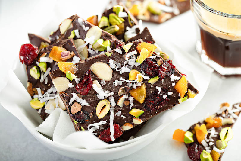 Chocolate Nut Bark in a White Bowl Lined with Parchment Paper