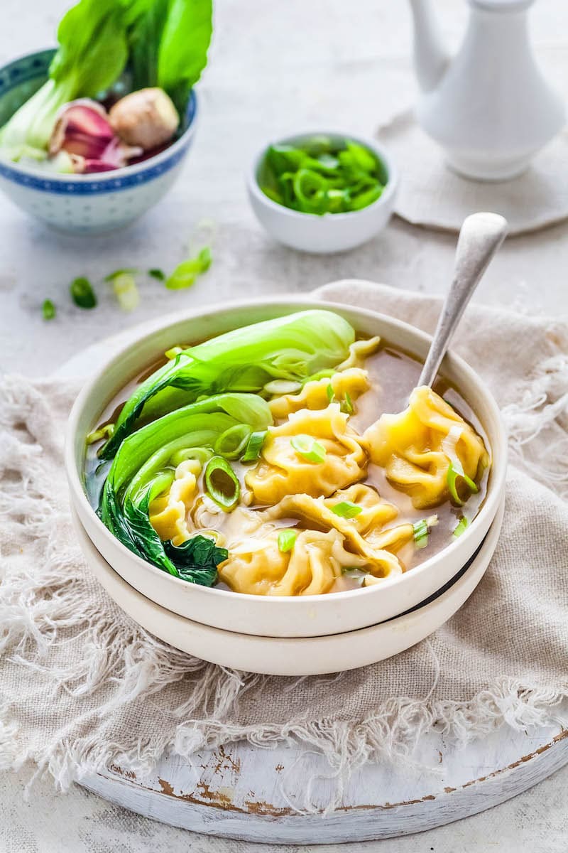 Wonton Soup Recipe in a white bowl with bok choy.