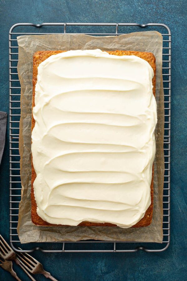 Banana Pecan Cake with creamed cheese frosting spread on top.