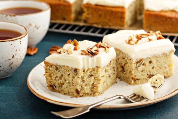 Two slices of Banana Pecan Cake with a fork.