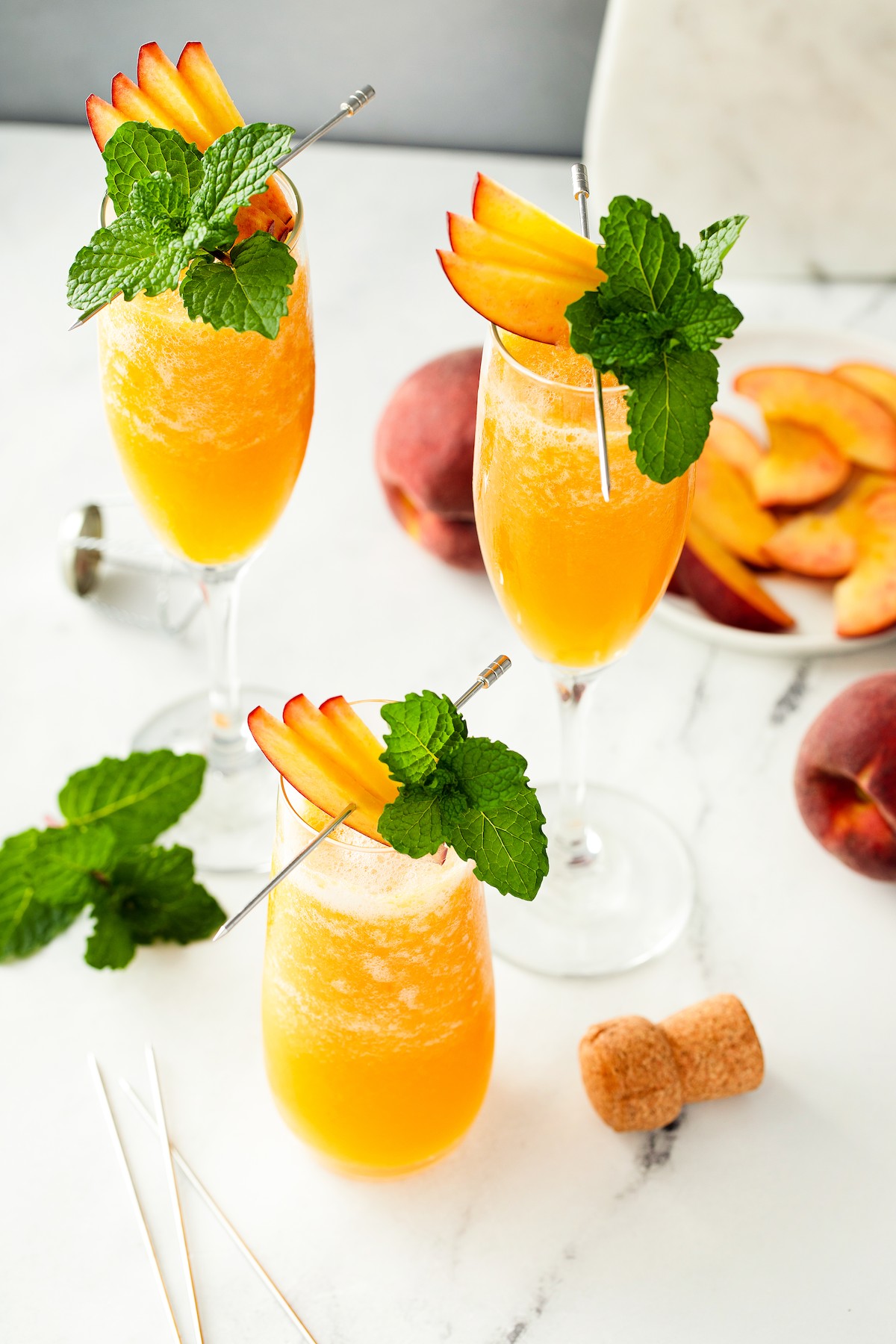 Frozen peach cocktails on a white table.