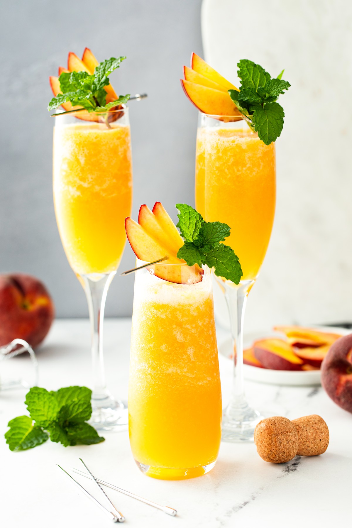 Three frozen peach bellinis with mint.