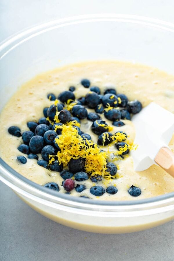 Buttermilk Blueberry Bread dough in a bowl with fresh blueberries and lemon zest.