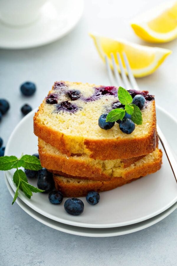 Buttermilk Blueberry Bread stacked on a white plate.