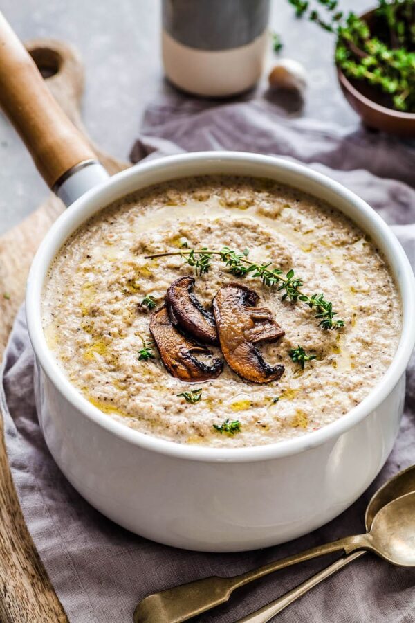 Creamy Roasted Mushroom Soup in a large pot with roasted mushrooms on top.