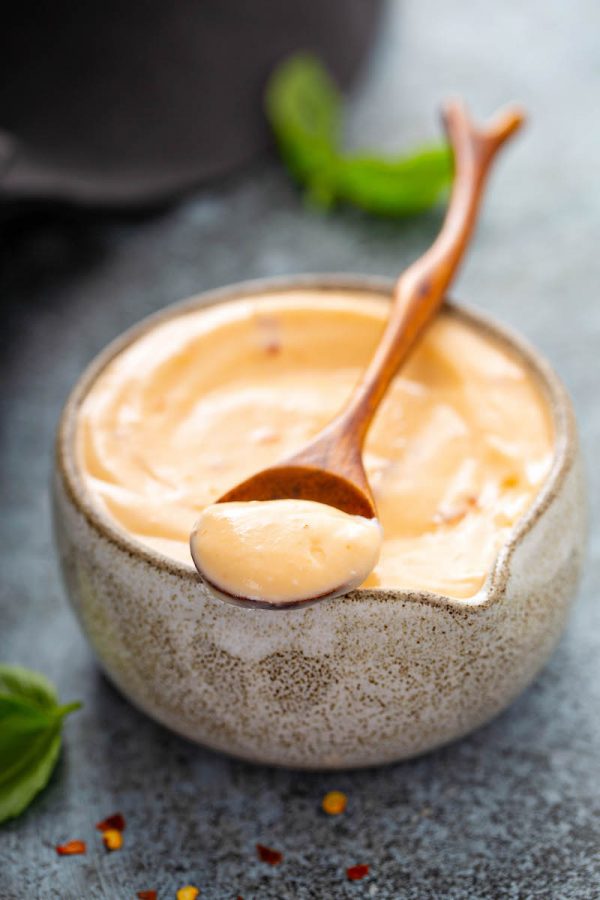 Creamy Sweet Chili Sauce in a bowl with a spoonful of dipping sauce.