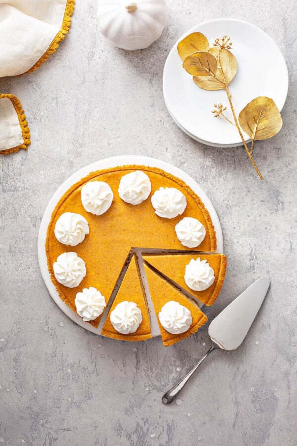 Pumpkin Pie Cheesecake sliced into pieces.