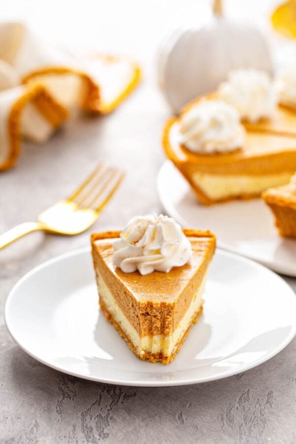 A slice of Pumpkin Pie Cheesecake with bite taken out of it.