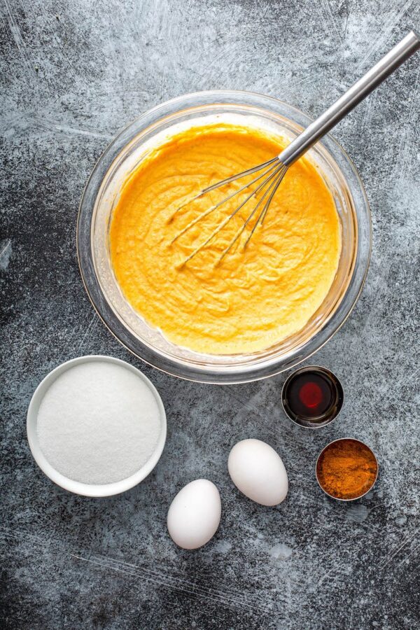 Ingredients for pumpkin bars in glass bowls.