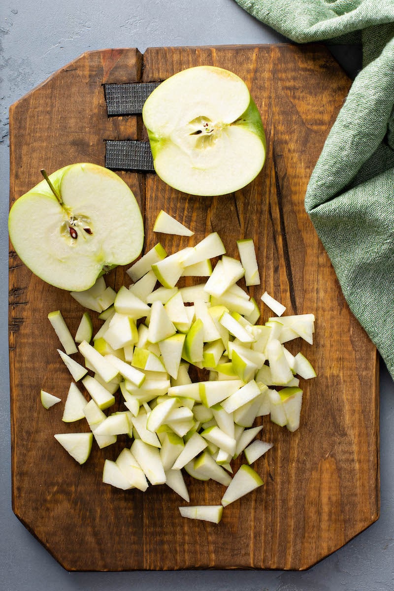 Diced apples on a chopping board for apple pie bombs.