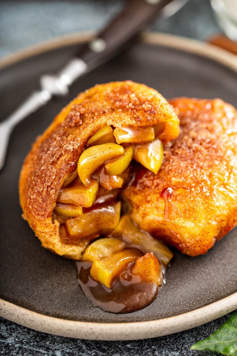 Apple Pie Bombs cut in half on a plate.