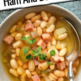 Easy crockpot ham and bean soup is in a bowl with a spoon.