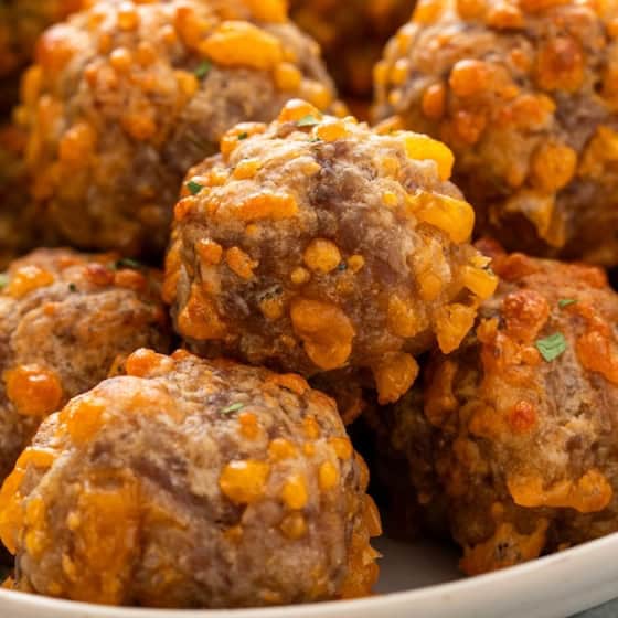 Easy sausage balls recipe with bisquick presented in a white bowl.