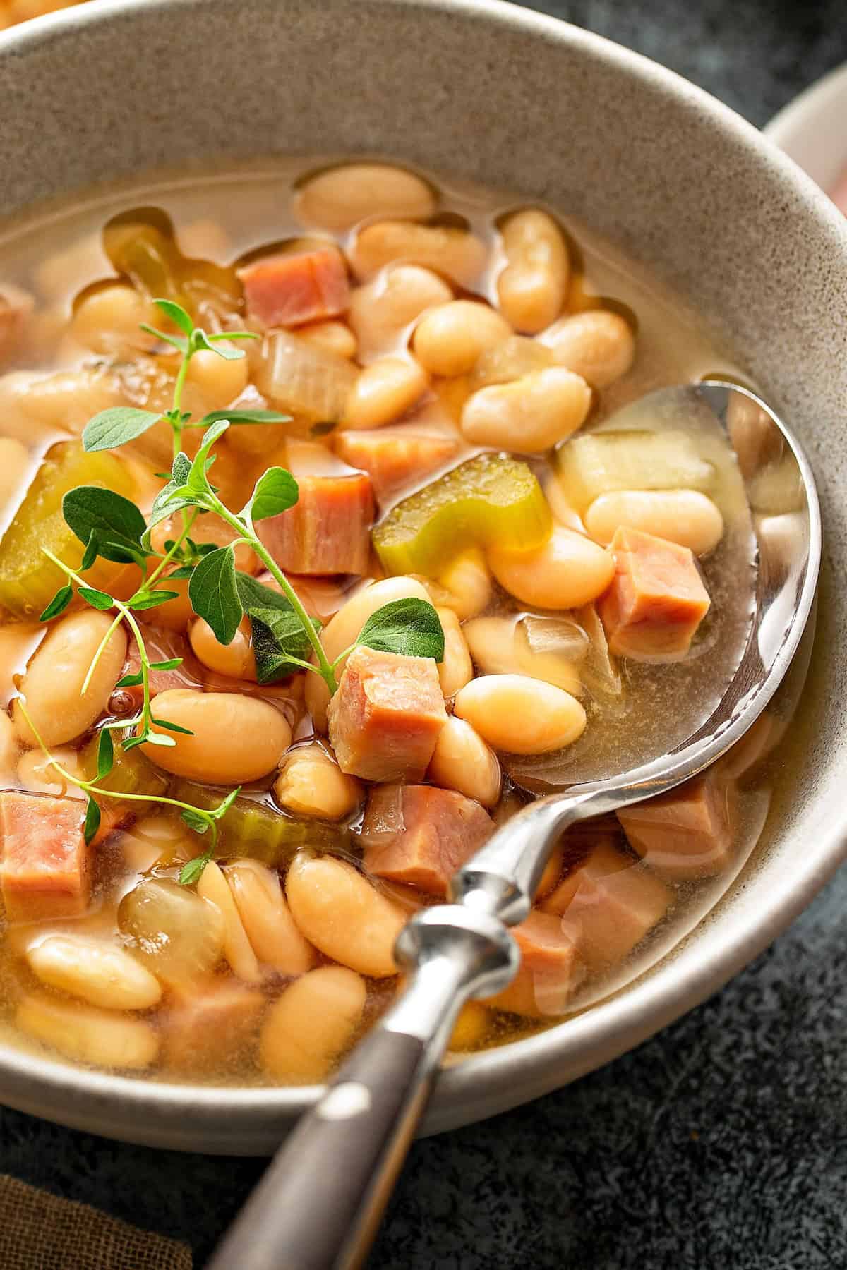 Slow cooker ham and white bean soup recipe presented in a bowl.