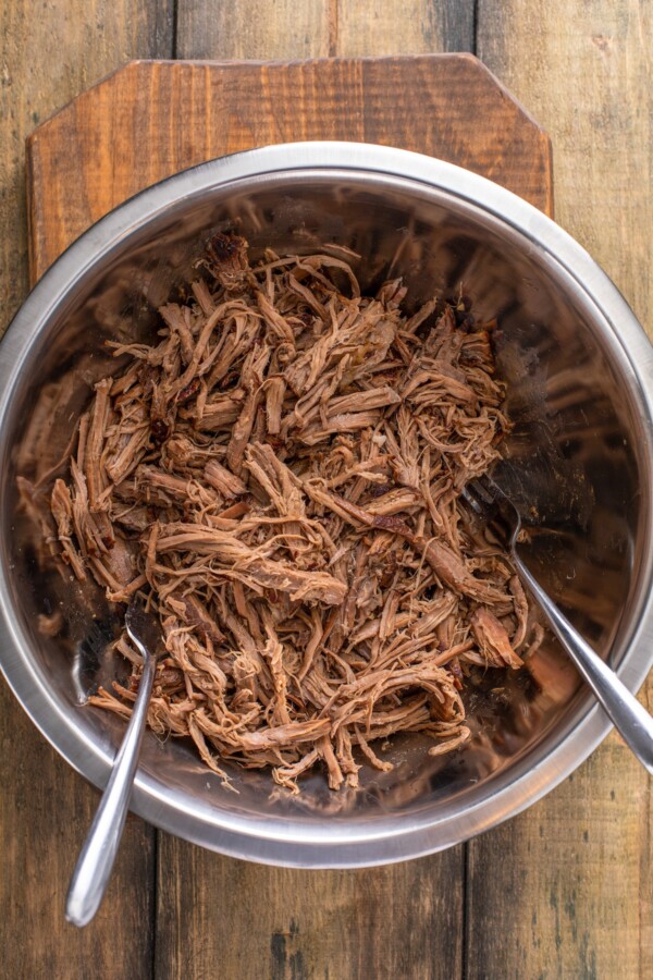 Shredded bottom round roast in a slow cooker.