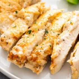 A sliced parmesan chicken breast is cooked all the way through.