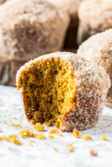 Donut Pumpkin Muffins with a bite taken out of it.