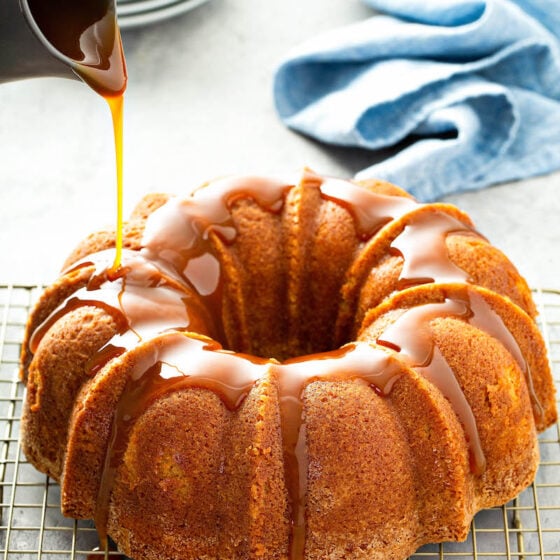Butterbeer Pound Cake on a cooling rack with butterscotch sauce.