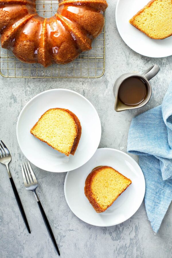 Butterbeer Pound Cake sliced on white plates with forks.