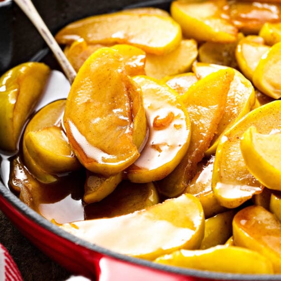 Spooning apples out of a skillet.