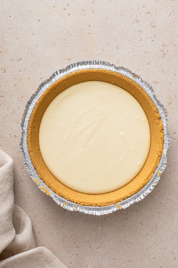 Cheesecake layer presented in a pie dish.