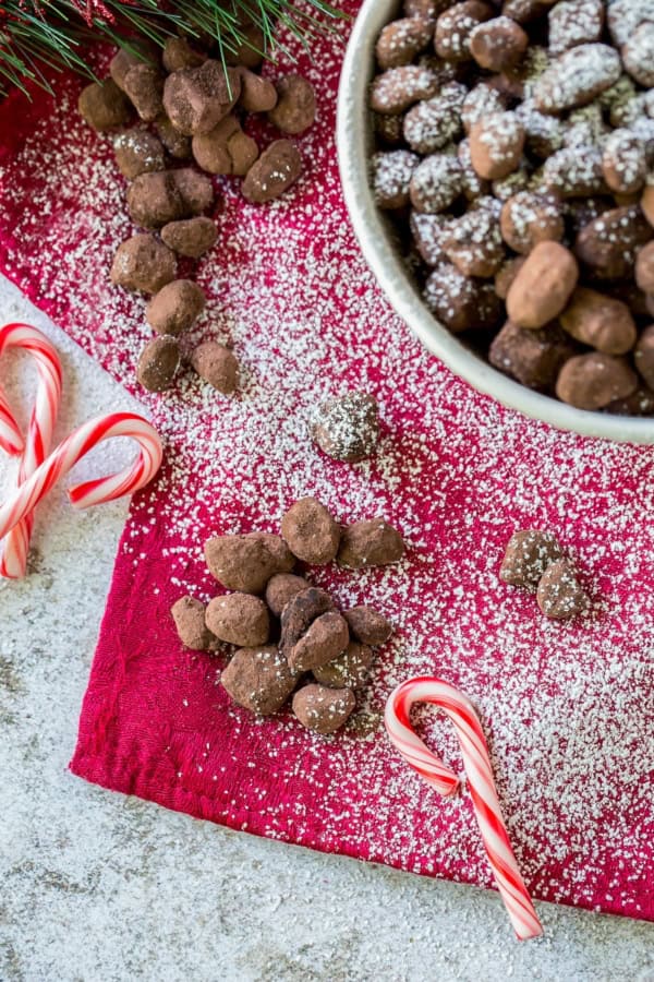 Candy canes are placed next to a bowl of easy Christmas reindeer poop.