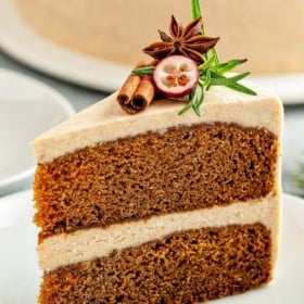 Two layers of homemade gingerbread cake are assembled with thick cinnamon cream cheese frosting.