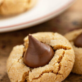 These Peanut Butter Blossoms are a Christmas tradiiton! Sweet peanut butter cookies are rolled in sparkling sugar, with a milk chocolate kiss in the center! #PeanutButterBlossoms #PeanutButterBlossomsRecipe #PeanutButterBlossomCookie #Dessert #ChristmasCookie #Cookie #CookieRecipe #ChristmasCookieRecipe #PeanutButterCookie #PeanutButterCookieRecipe #PeanutButterKissCookies #ChristmasRecipes #PeanutButter