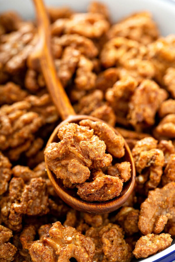 Toffee Walnuts in a wood spoon.