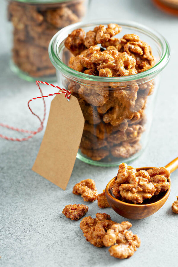 Toffee Walnuts in a glass jar with a gift tag.